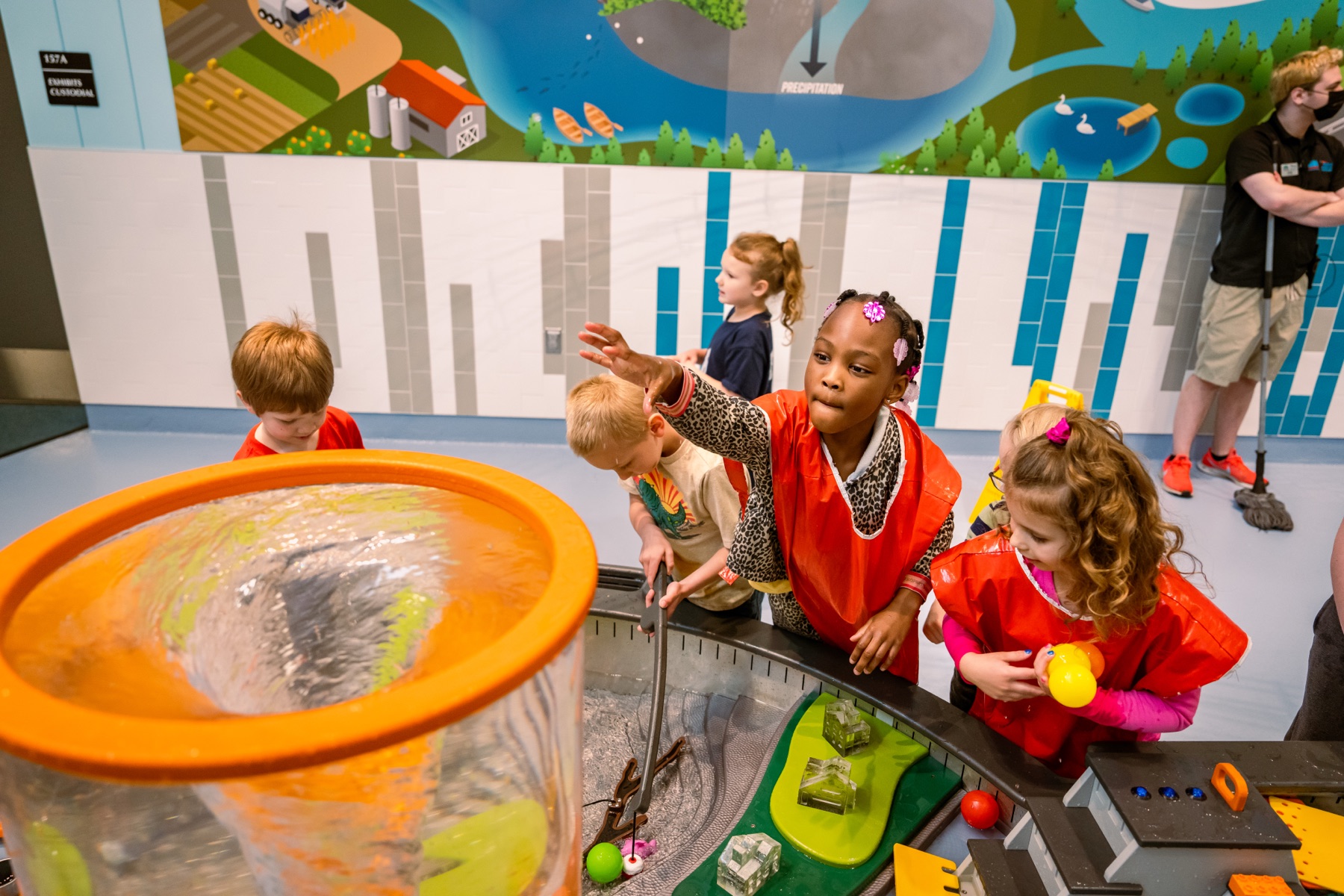 Children playing at a hands-on water and watershed exhibit at the Sloan Museum of Discovery